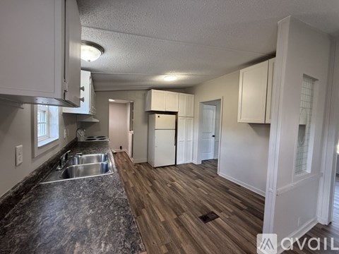 A kitchen with a sink and a counter top.