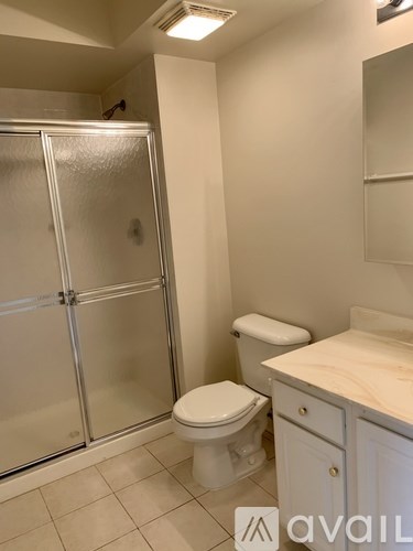 A bathroom with a toilet, sink, and shower.