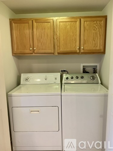 A white washer and dryer in a small laundry room.