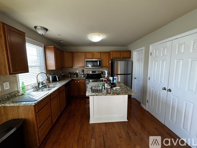 A kitchen with wooden cabinets and a granite countertop.