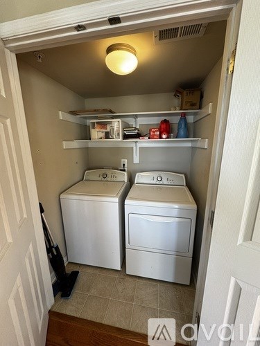 A small laundry room with a washer and dryer.