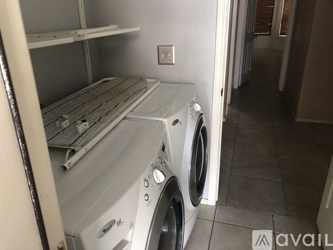 A washing machine is sitting in a laundry room.
