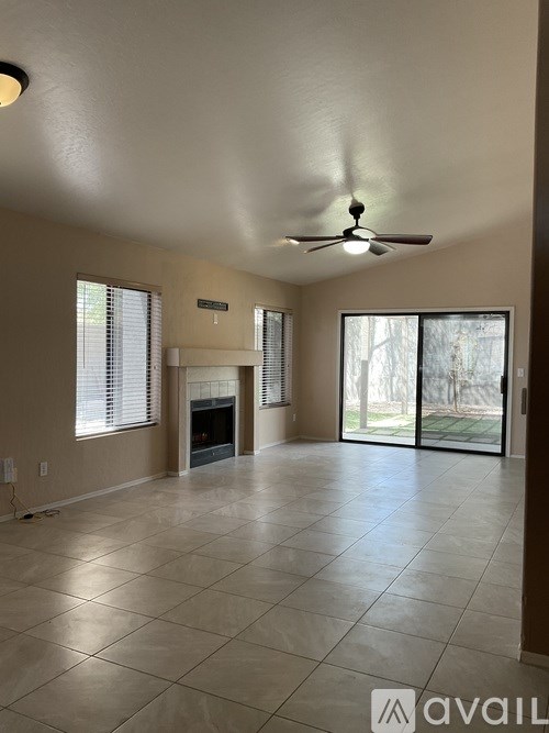 A spacious living room with a fireplace and sliding glass doors.