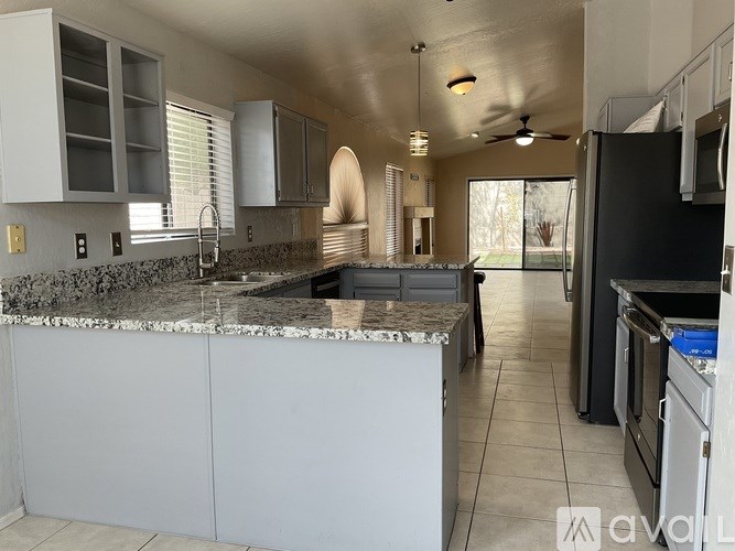 A kitchen with granite countertops and stainless steel appliances.