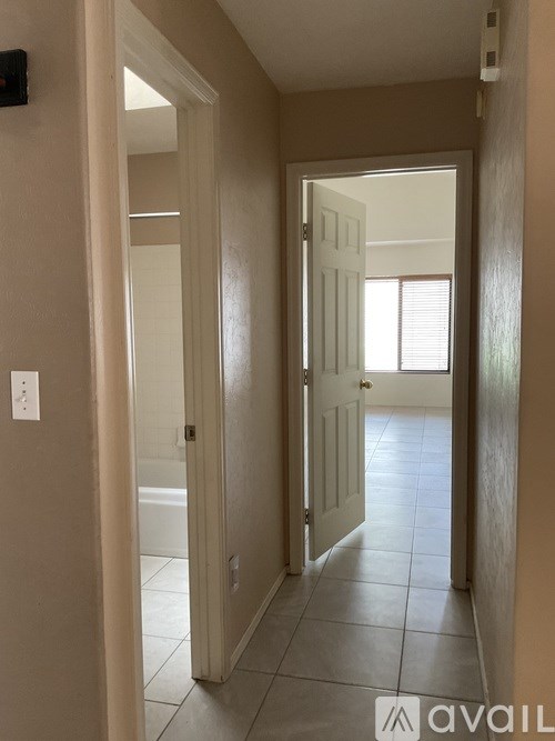 A hallway with a door on the left and another door on the right.