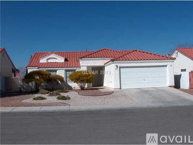 A house with a red roof and a garage door is for sale.