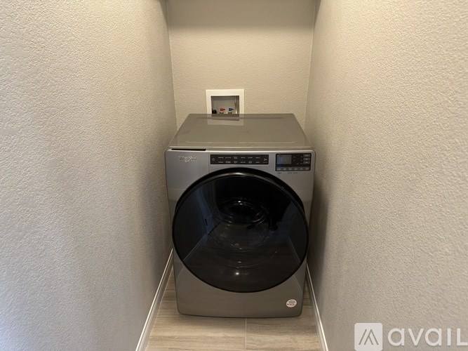 A washing machine is placed in a small room.