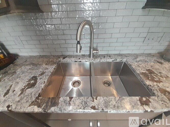 A modern stainless steel sink with a chrome faucet.
