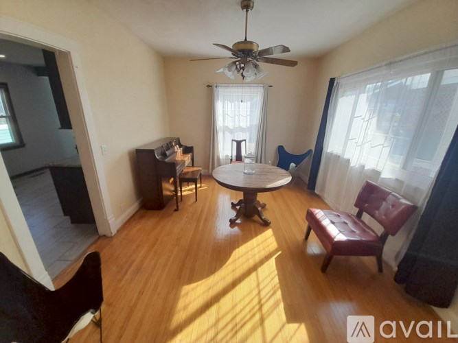 A living room with a round table and chairs.