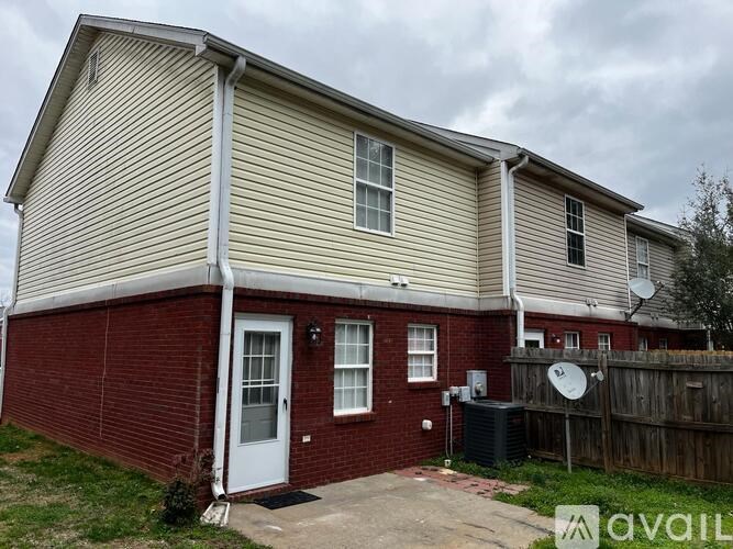 A house with a red brick wall and a white door.