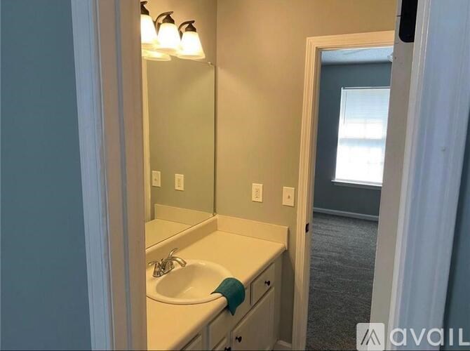 A bathroom with a sink and mirror.