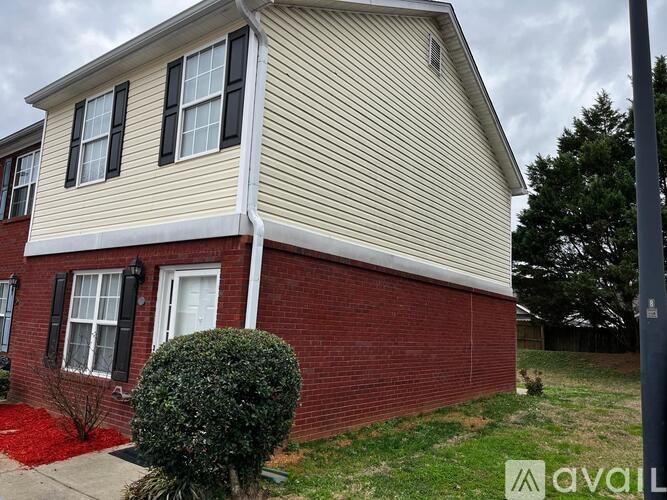 A house with a red brick wall and a white door.