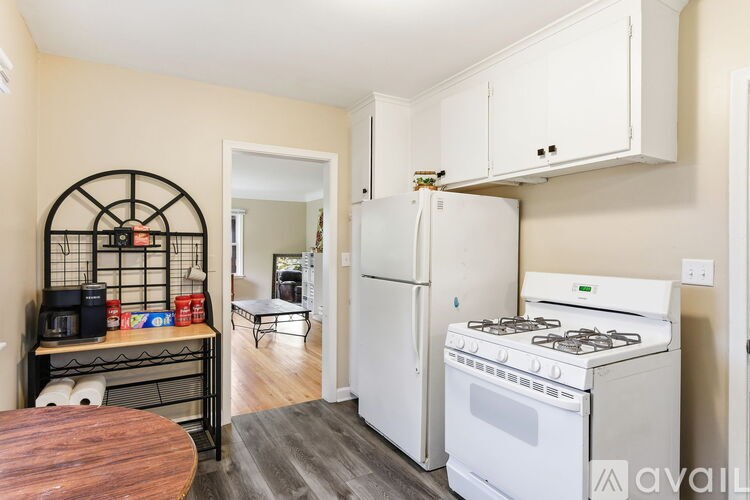 A kitchen with a white fridge and stove.