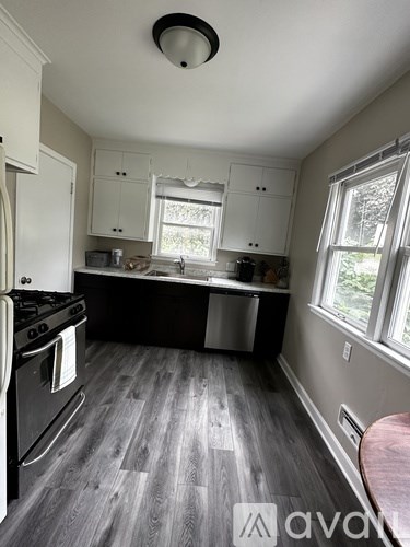 A kitchen with a stove top oven and a dishwasher.