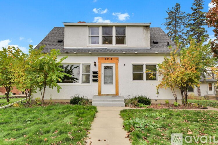 A house with a brown door and a small front yard.