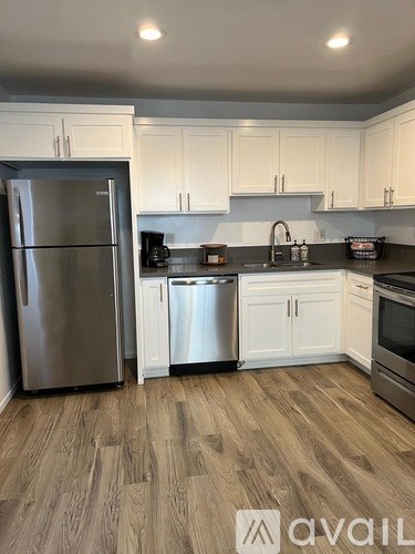 A kitchen with a refrigerator, dishwasher, and oven.