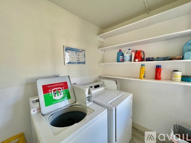 A small laundry room with a washing machine and a dryer.