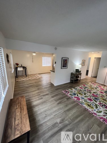 A room with wooden floors and a bench.