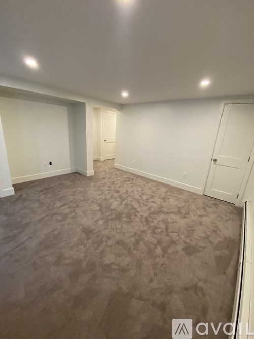 A room with carpeted floor and white walls.