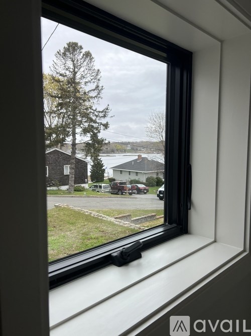 A window with a view of a residential area outside.