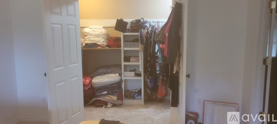 A room with a lot of clutter and a sign that says "available".