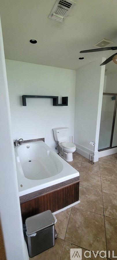 A bathroom with a toilet, sink, and mirror.