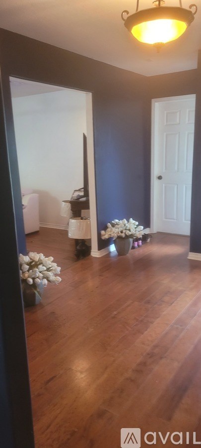 A room with wooden floors and a white door.