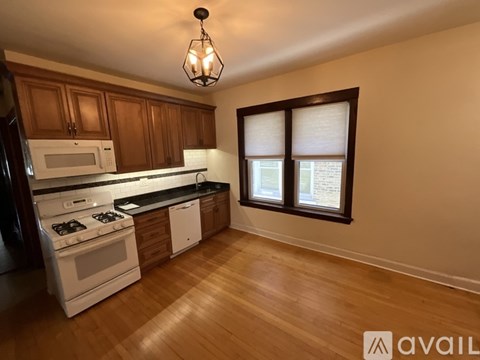 A kitchen with wooden cabinets and a white stove top oven.