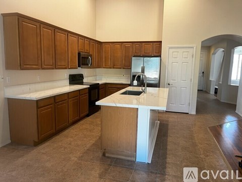 A kitchen with brown cabinets and a white island.