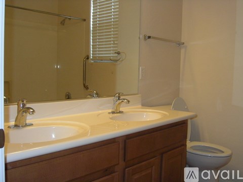 A bathroom with a white sink and a toilet.