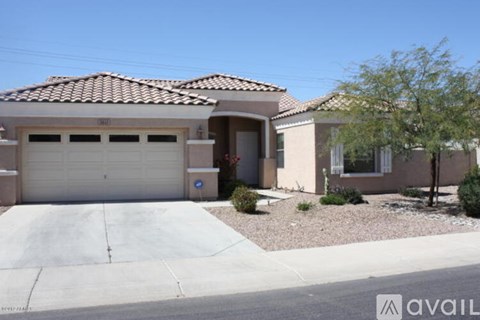 A house with a garage and a driveway in front.