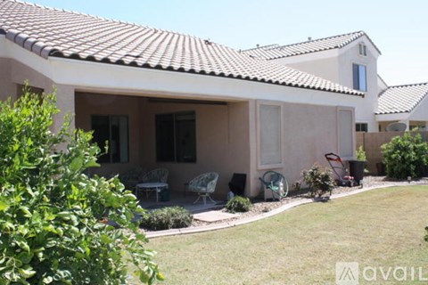 A house with a patio and a lawn.