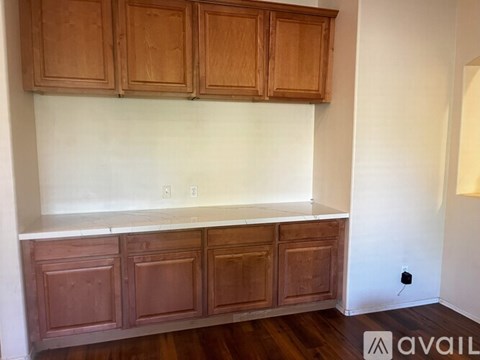 A kitchen with wooden cabinets and a white countertop.
