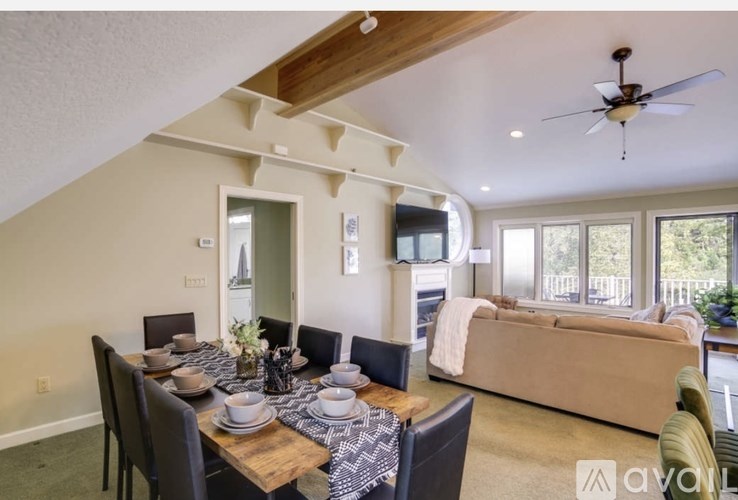 A dining room with a wooden table set for six.