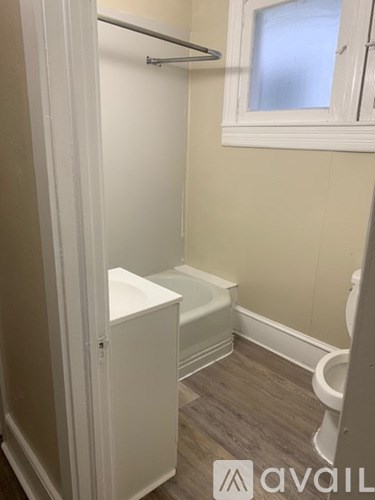A bathroom with a toilet, sink, and bathtub.