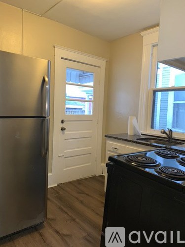 A kitchen with a stove and a refrigerator.