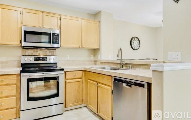 A kitchen with wooden cabinets and stainless steel appliances.