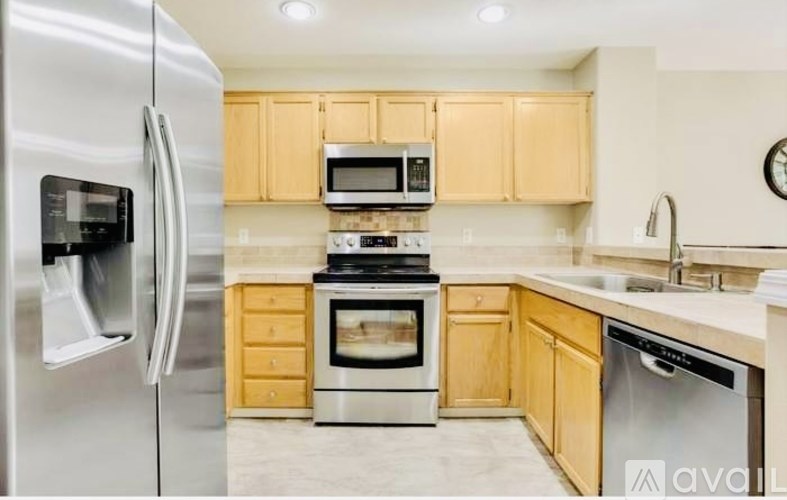 A kitchen with wooden cabinets and stainless steel appliances.