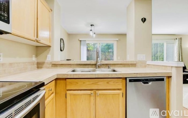 A kitchen with wooden cabinets and a white countertop.
