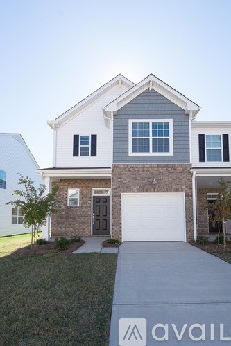 A house with a garage and a driveway in front.