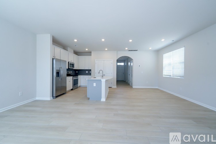A spacious kitchen with a refrigerator, microwave, and oven.
