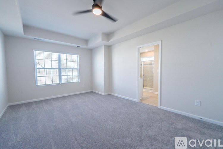 A spacious room with a ceiling fan and a window.