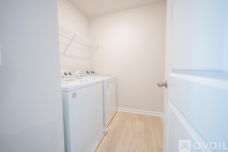 A small laundry room with a washer and dryer.