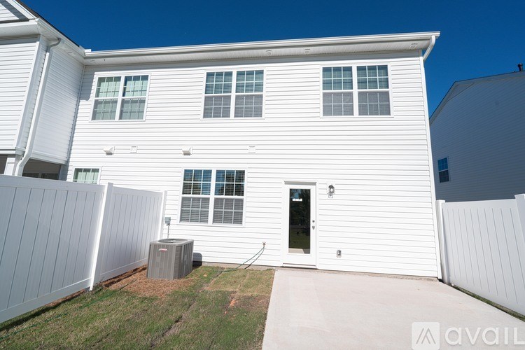 A white house with a black door and a small window.
