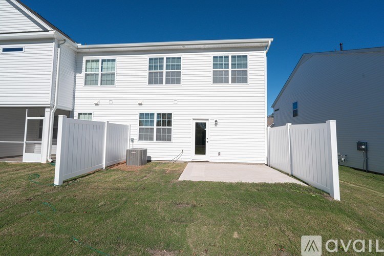 A white house with a black door and a small porch.