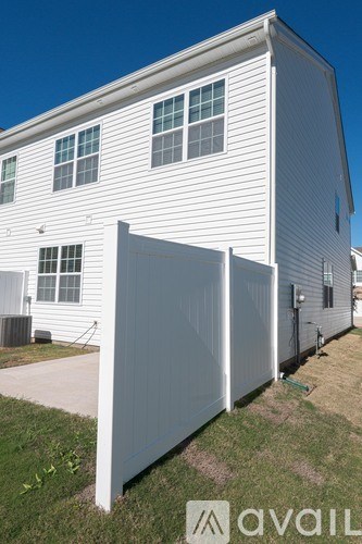 A white house with a grey garage door.