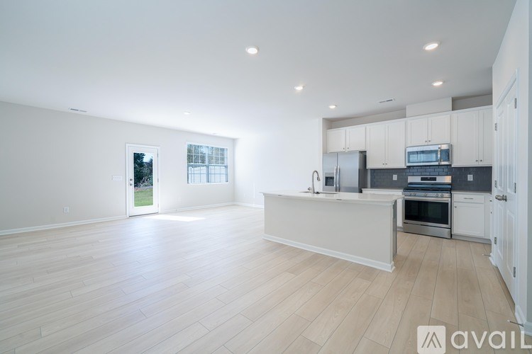 A spacious kitchen with white cabinets and a large island.