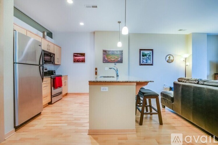 A kitchen with a refrigerator, stove, and island.