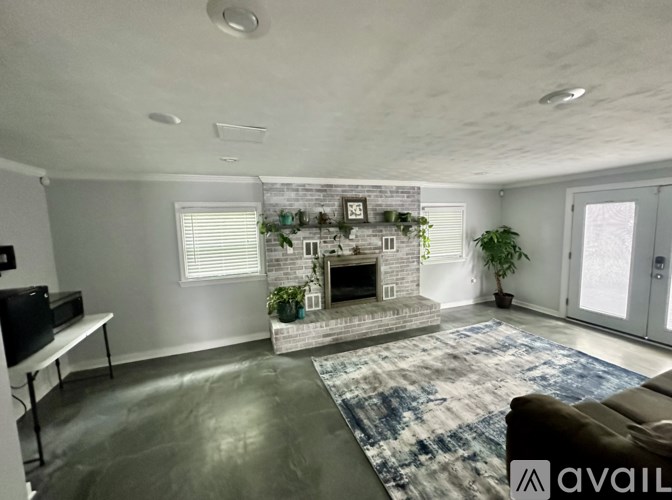 A living room with a fireplace and a flat screen TV.