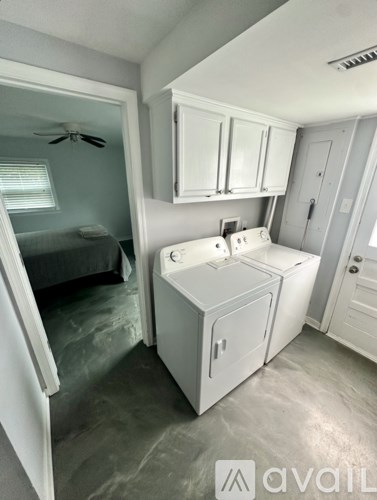 A small white kitchen with a refrigerator and a sink.